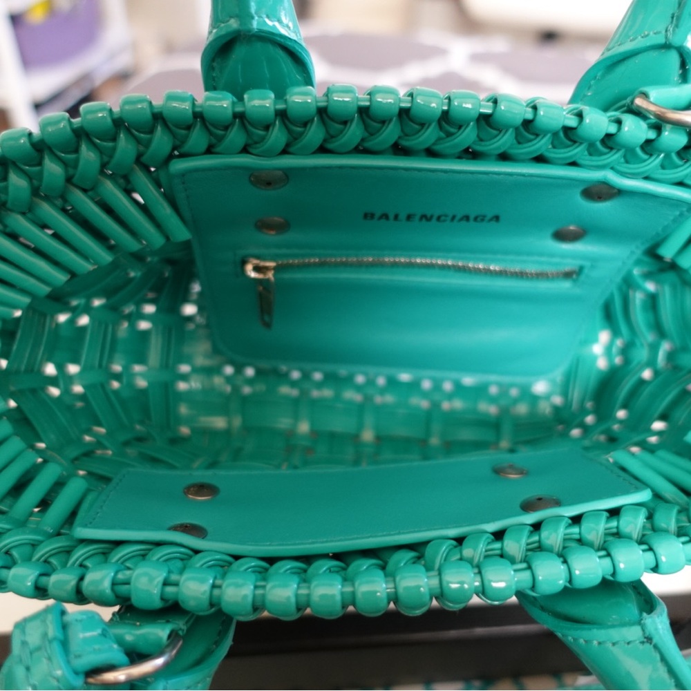 A turquoise balenciaga purse